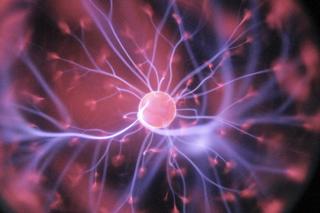 Abstract plasma energy field with glowing electric currents, representing atomic structure and electron movement.